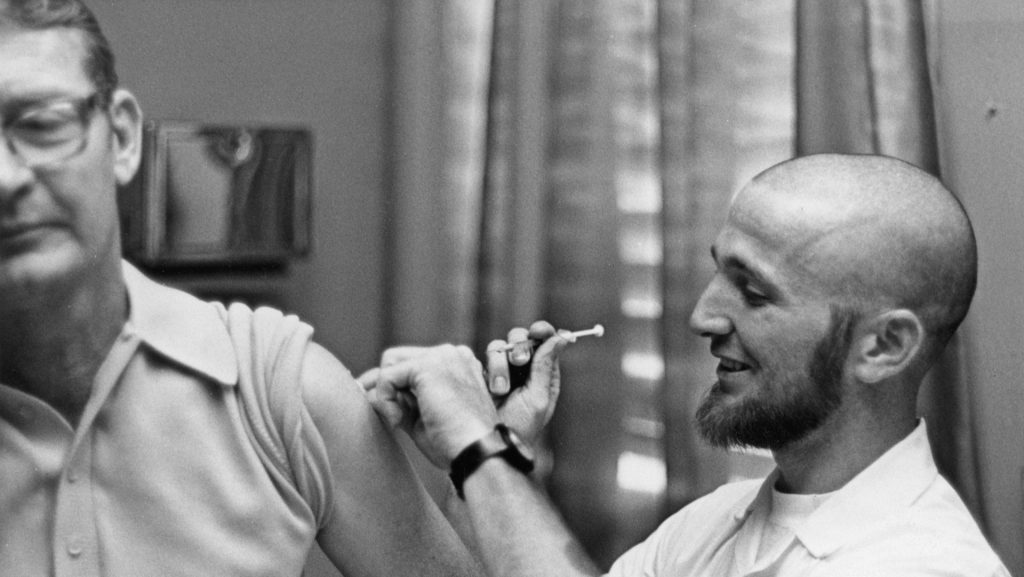 Doctor gives patient a vaccine shot