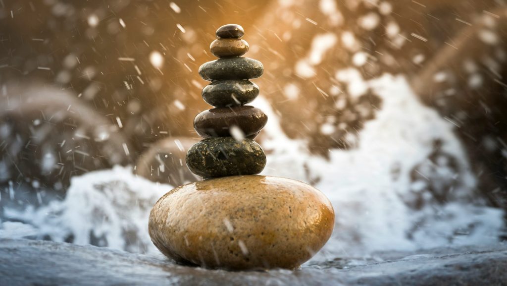 a stack of rocks sitting on top of a river